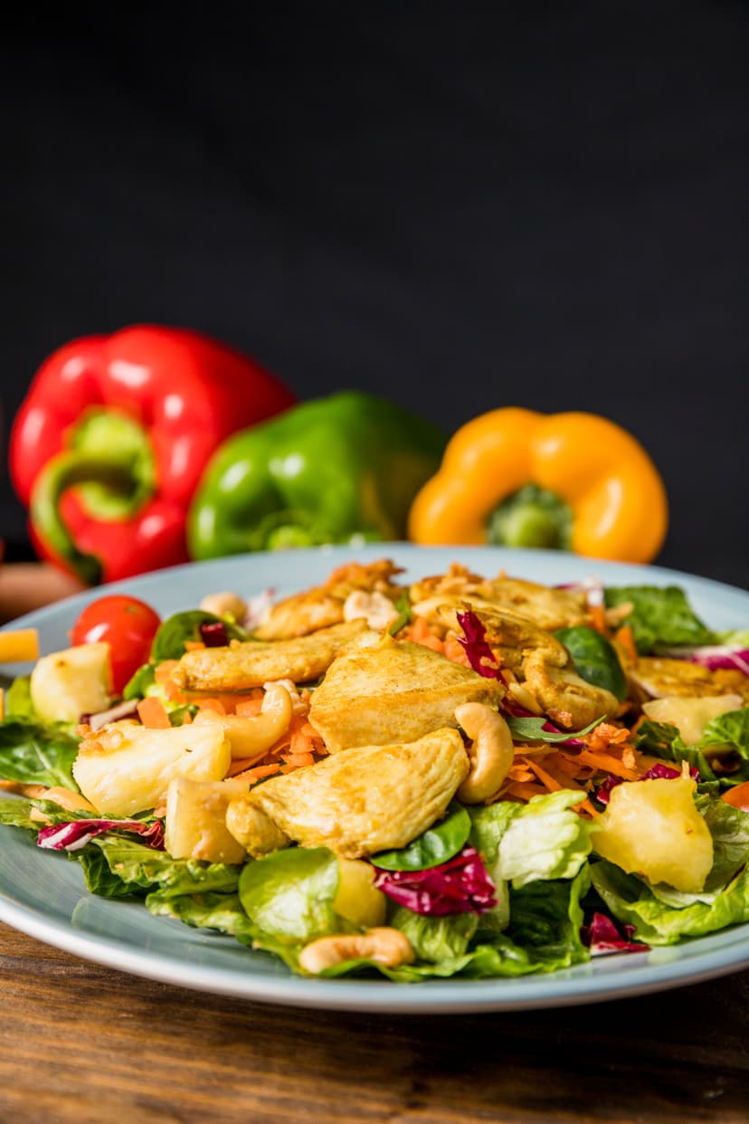 delicious-salad-with-chicken-nuts-vegetables-desk-against-black-background.jpg